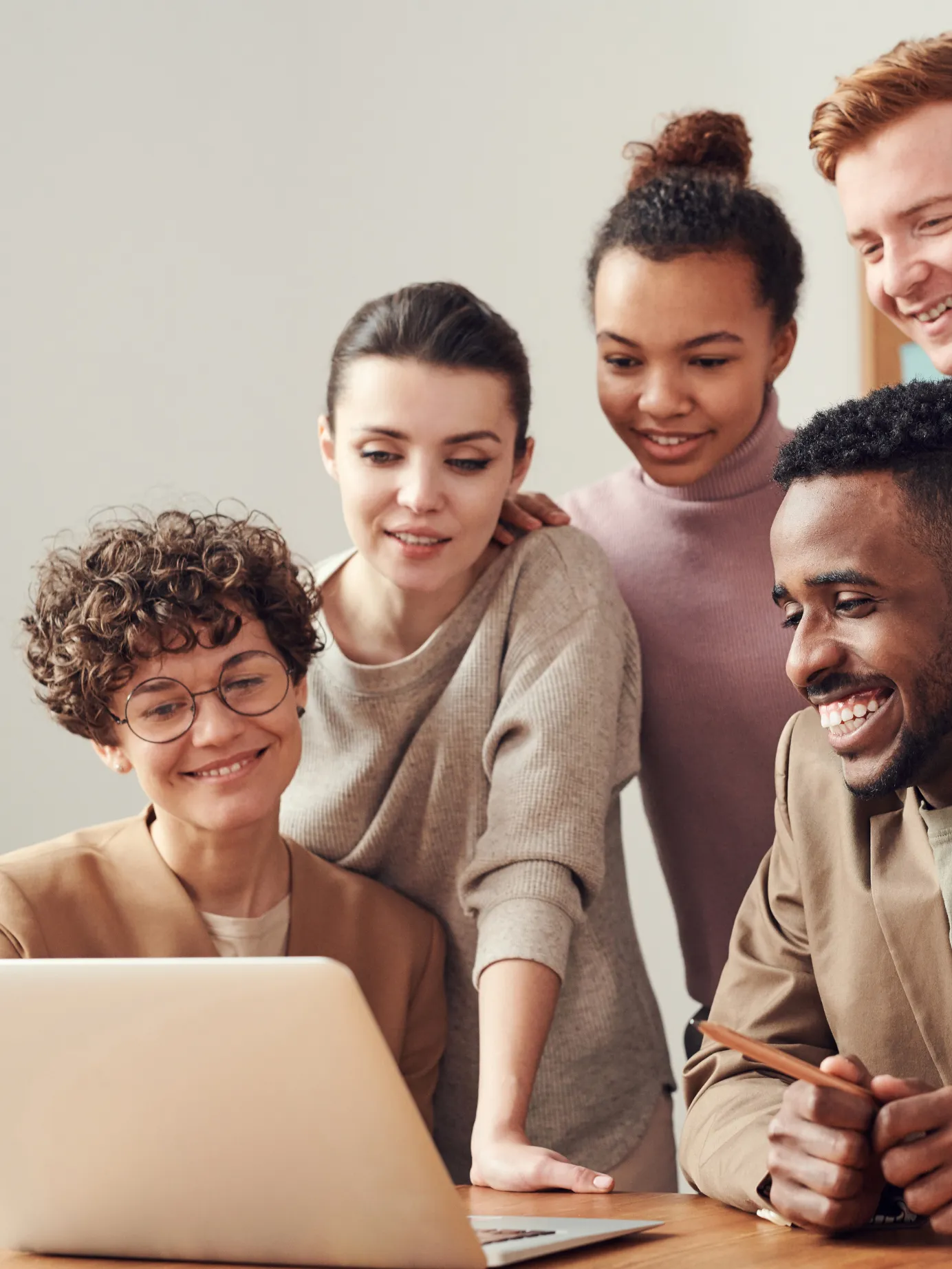 Diverse marketing team reviewing campaign results on a laptop